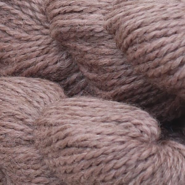 Close up image of rope shaped wool in light pink color